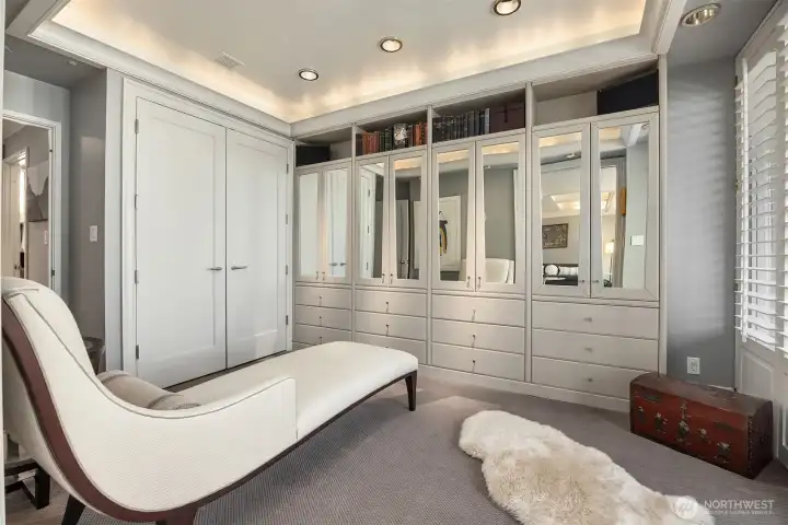 Secondary bedroom, currently used as owners dressing room, offers direct balcony access and abundant storage and closet space.