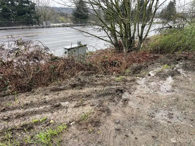 View of freeway and round about dead end street in front of property on wallace street. There is power pole over head and power box near highway to connect to.  Property will have wonderful views to the west of sunsets when cleared and built on
