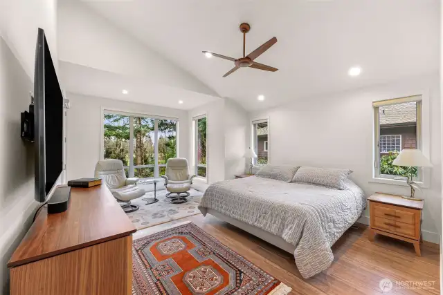 The primary bedroom has plenty of room for a king bed, your furnishings and a lovely reading nook, that also accesses the back porch.