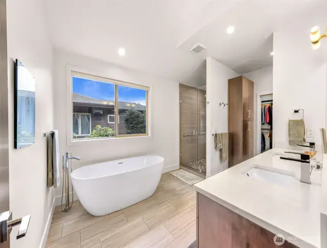 The primary bathroom has a freestanding tub and walk in shower.  New tile and countertops were added by the owners.
