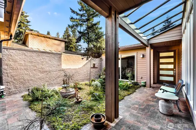 Interior Courtyard with covered walkway to the front door.  Office/gym is behind the sliding door to the left