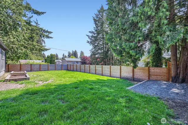 The backyard is huge!.  Two elevated garden boxes for all your vegetables