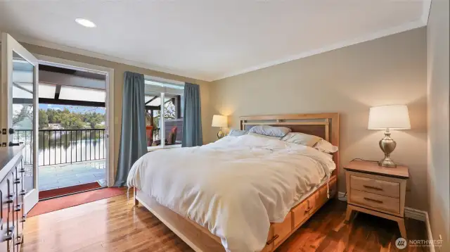 Main floor primary suite with access to covered deck. Great lake views