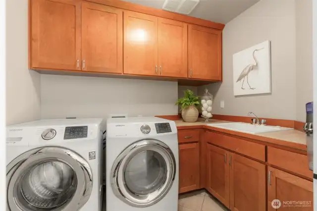 Laundry with folding spaces and storage.
