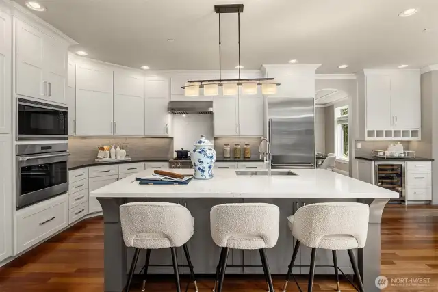 Chef-inspired kitchen with quartz countertops and designer tile backsplash.