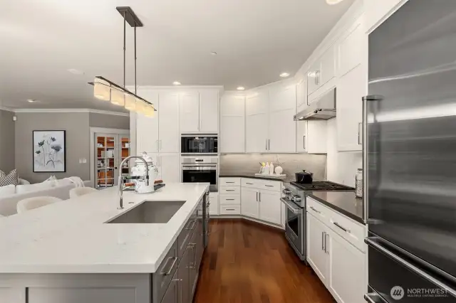 Premium appliance suite: Sub-Zero refrigerator, Wolf range, Viking ovens, and Miele dishwasher.