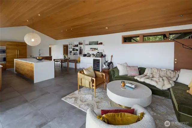 Another look at the great room combining kitchen, dining and living. The vaulted ceilings are clear fir with recessed lighting and the whole space is bathed in natural light.