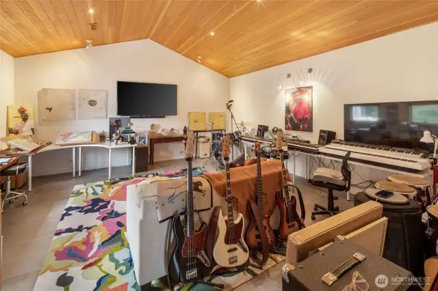 The second room is currently used as a music studio. It features the same clear fir vaulted ceilings and recessed lighting as the rest of the house.