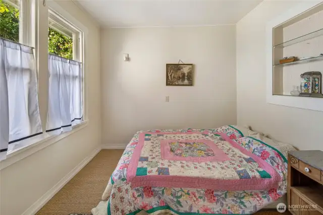 The bedroom on the main level of the farmhouse. It also features a bonus room on the main level.