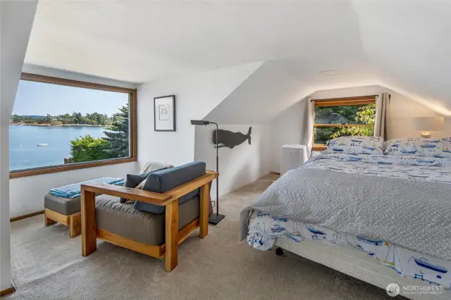 The bedroom on the upper level of the farmhouse features a picture windows to take in the spectacular view. There is a second bathroom on the upper level and a separate entrance as well.