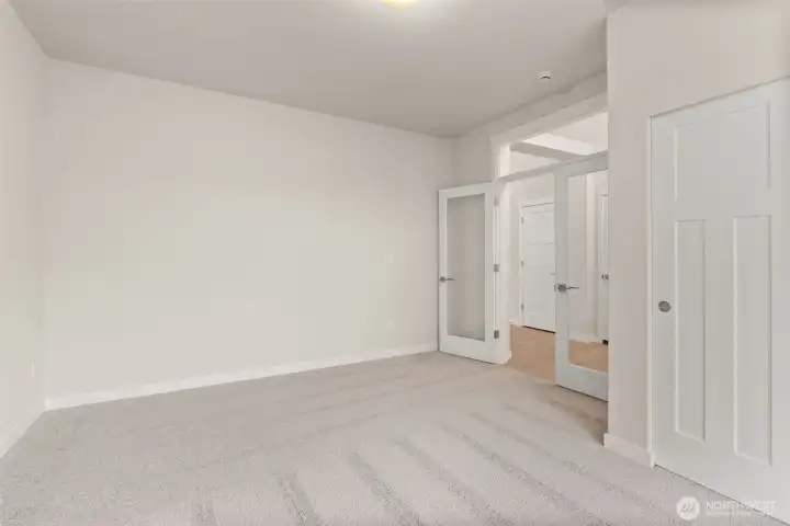 Off the front entry hall clear glass doors open into what could be a den/office space or a 3rd bedroom.