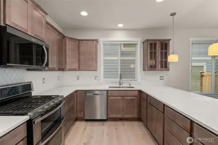 Whirlpool stainless steel gas double oven is standard as well as dishwasher and microwave. This home includes a refrigerator.