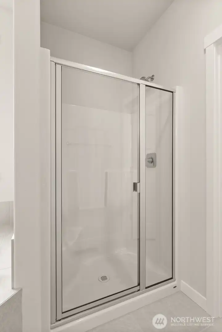 Primary bathroom comes with a standard separate walk-in shower with glass door and a separate, private water closet.