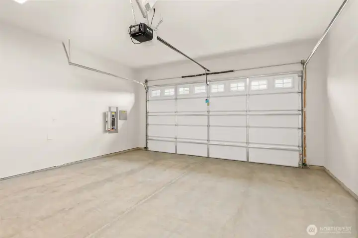 Double car garage is drywalled and includes garage door opener.