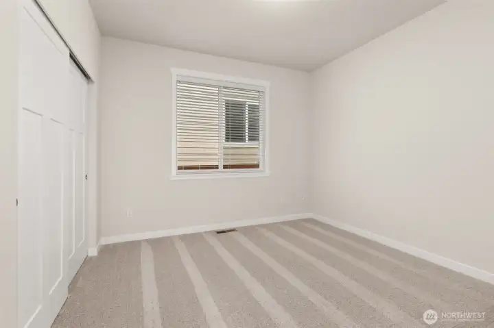 Adjacent to full bathroom is the second bedroom featuring a large reach-in closet.