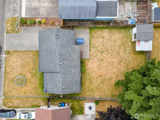 Fully fenced yard with large shed and covered lean too for more storage.