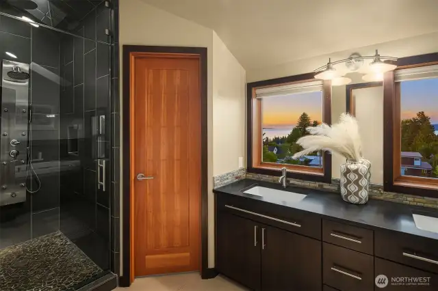 Double sinks and walk-in shower with 8 sprayer heads in primary bathroom + those views!