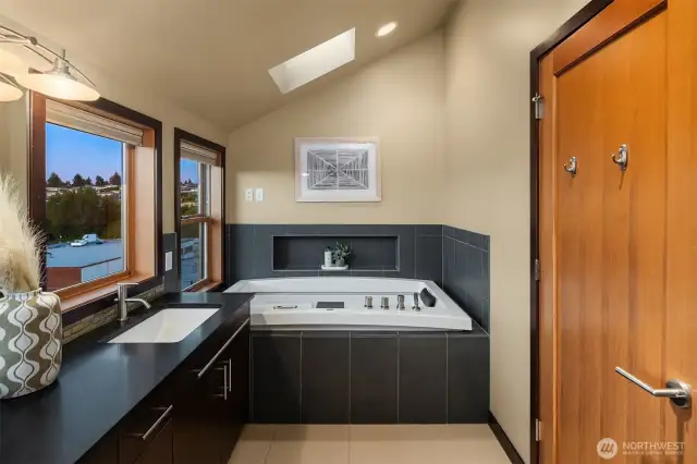 Jetted smart tub with lights and heated tile flooring.