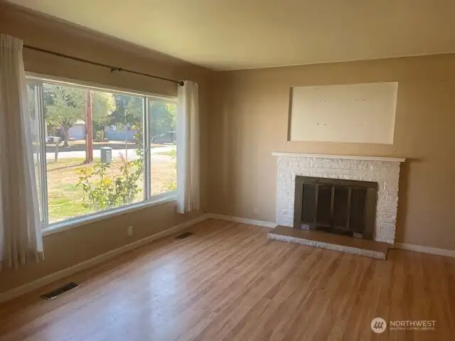 Open, bright living room with fireplace.