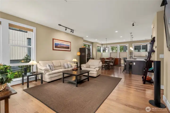 Gathering area with wood floors & reversable blinds for perfect light and privacy.