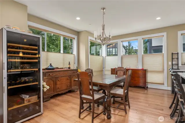 Large dining area adjacent to kitchen and walls of windows.