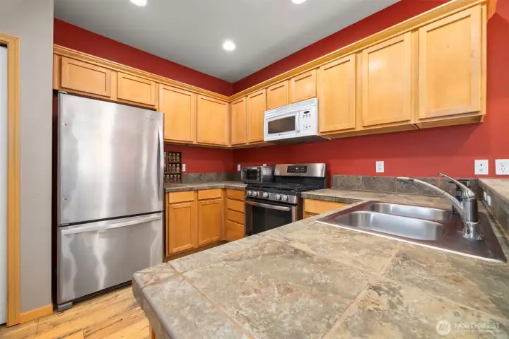 The kitchen is spacious with a lot of counter and cabinet space.