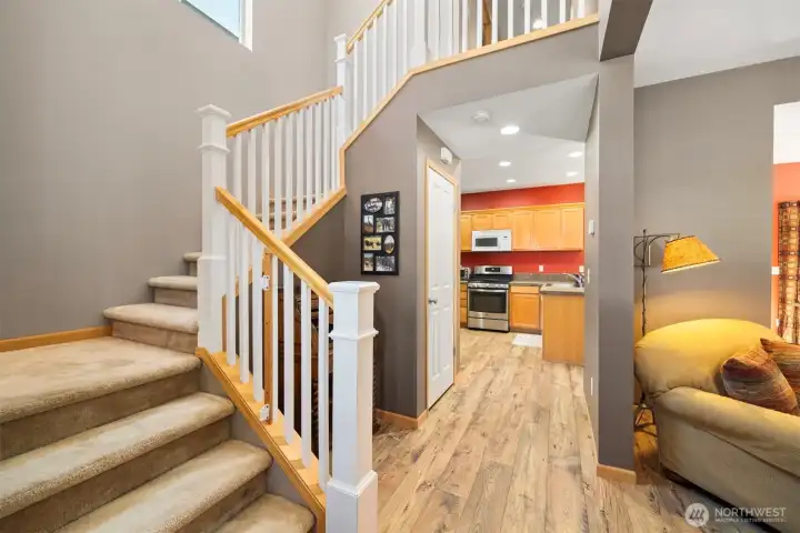 From the entry there is the stairway to the beds, baths and laundry with the kitchen beyond.