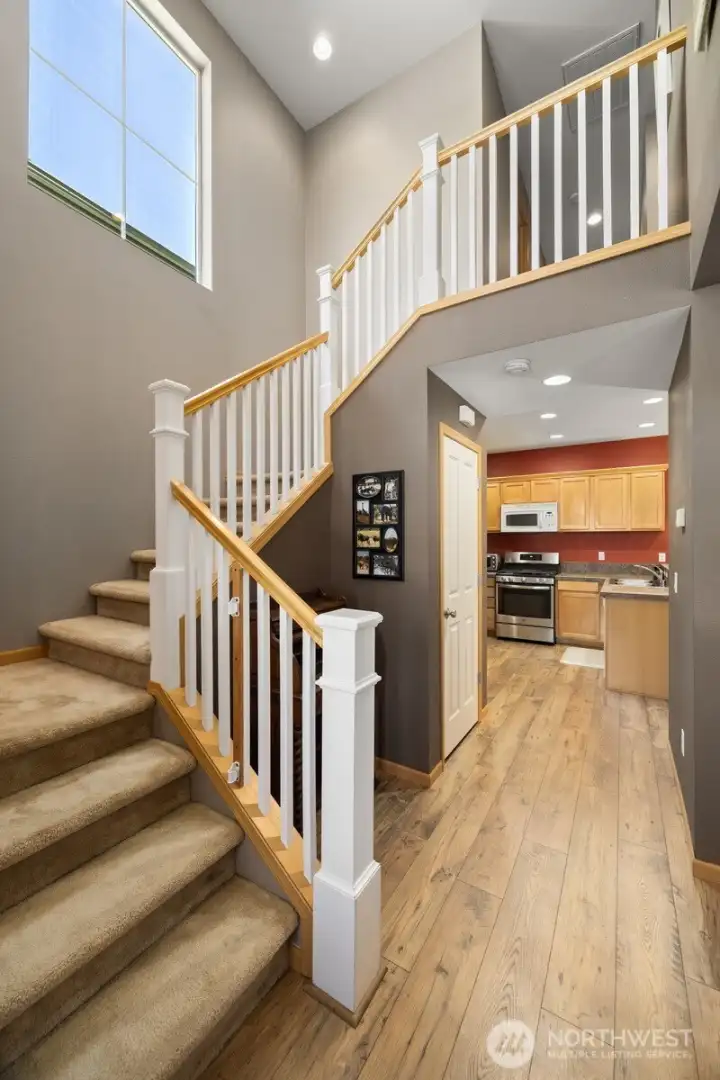 Another view of the stairway with the kitchen beyond.