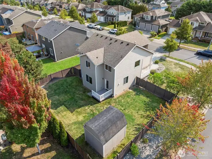 An aerial view from the back of the property showing the full fenced back yard with 10x12' shed.