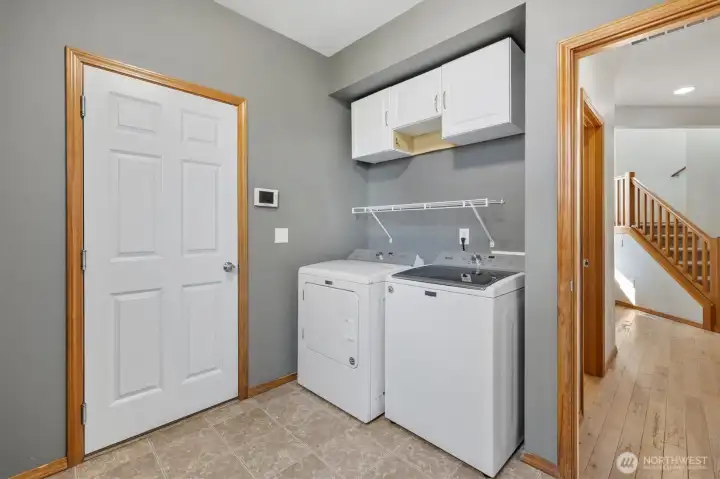 The spacious laundry room connecting the house to the 2 car garage