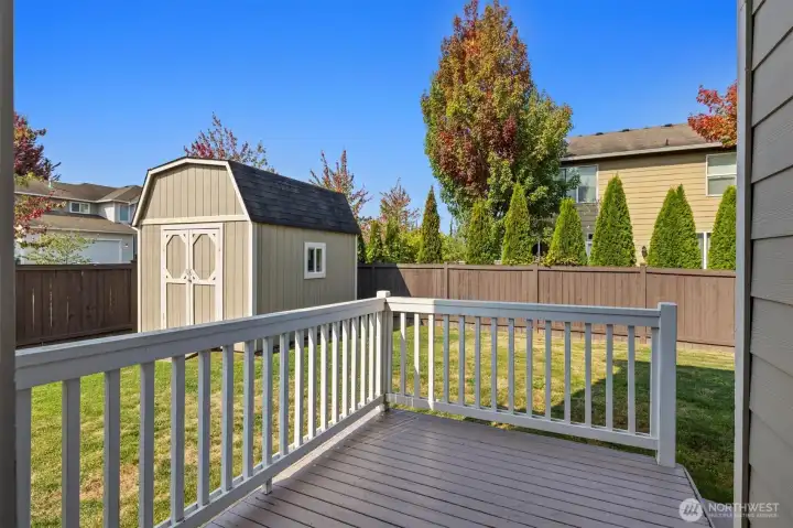 The deck off of the kitchen leading to the spacious well cared for and fully fenced back yard