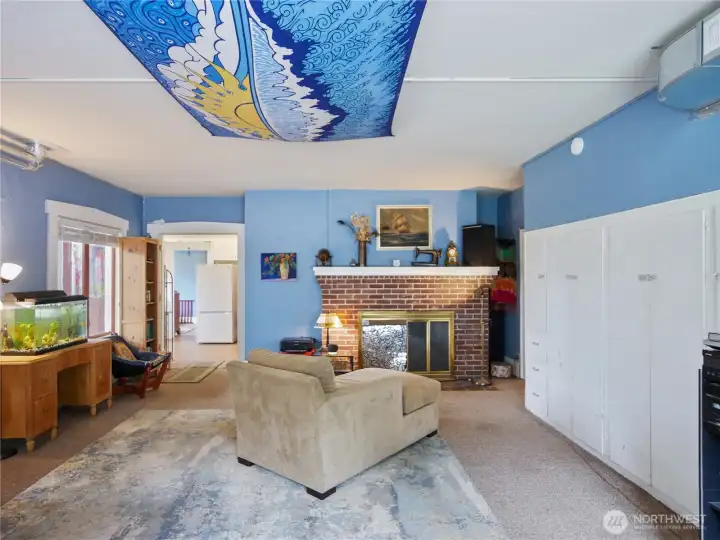 This is the large ADU family room with a working wood fireplace.