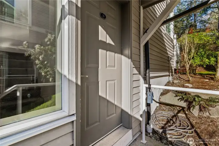 Exterior, private entry. Deadbolt can be unlocked via key or code, with secondary door handle lock beneath.