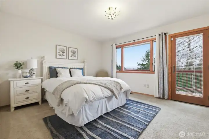 All of the bedrooms are generously-sized. This bedroom offers access to the deck and incredible views of Mt. Rainier.