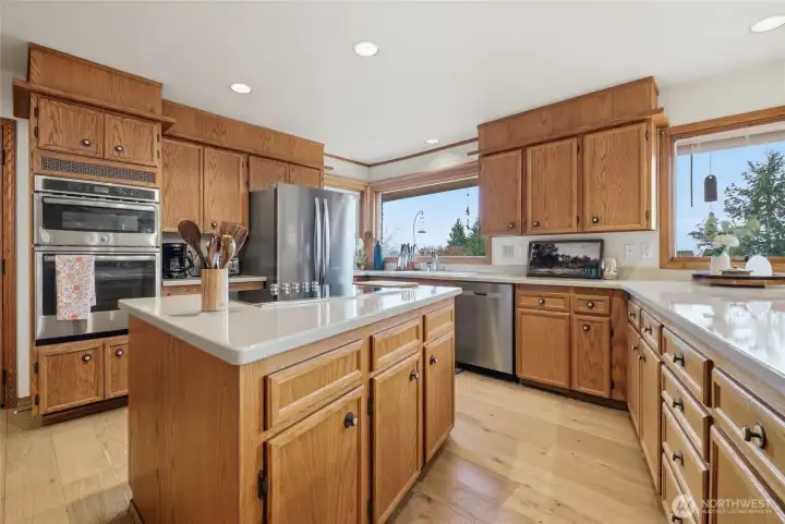 Another view of the large kitchen with updated countertops and newer appliances.