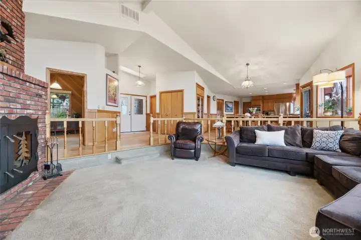 Spacious living room with cozy wood-burning fireplace.