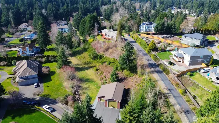 This aerial view shows the entire property, including the detached shop on the lower level and the rambler on the upper level of the property.