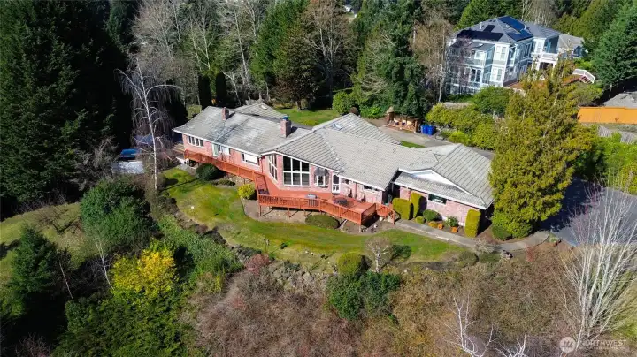 Perched above the landscape with sweeping views of Mount Rainier and the surrounding foothills, this architecturally designed Northwest retreat invites you to slow down, breathe deeply, and savor the beauty of the changing skies. From sunrise glow to dramatic weather rolling across the valley, every day brings a new natural masterpiece right outside your windows. Thoughtfully positioned for privacy and tranquility, the home feels worlds away—yet it’s conveniently close to town, offering the perfect balance of seclusion and accessibility. Expansive windows, warm natural materials, and a layout that embraces the outdoors create a sense of calm the moment you step inside this classic, one-level home.