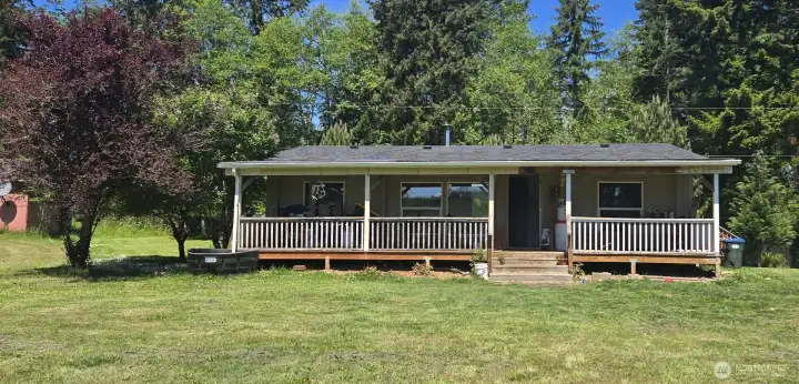 Full length covered front deck to enjoy a peaceful, beautiful view of the pond & open acreage.