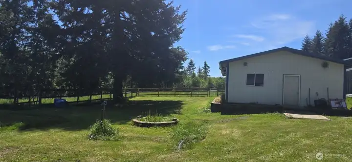 Side entrance of shop with view of new wood fence for pasture.