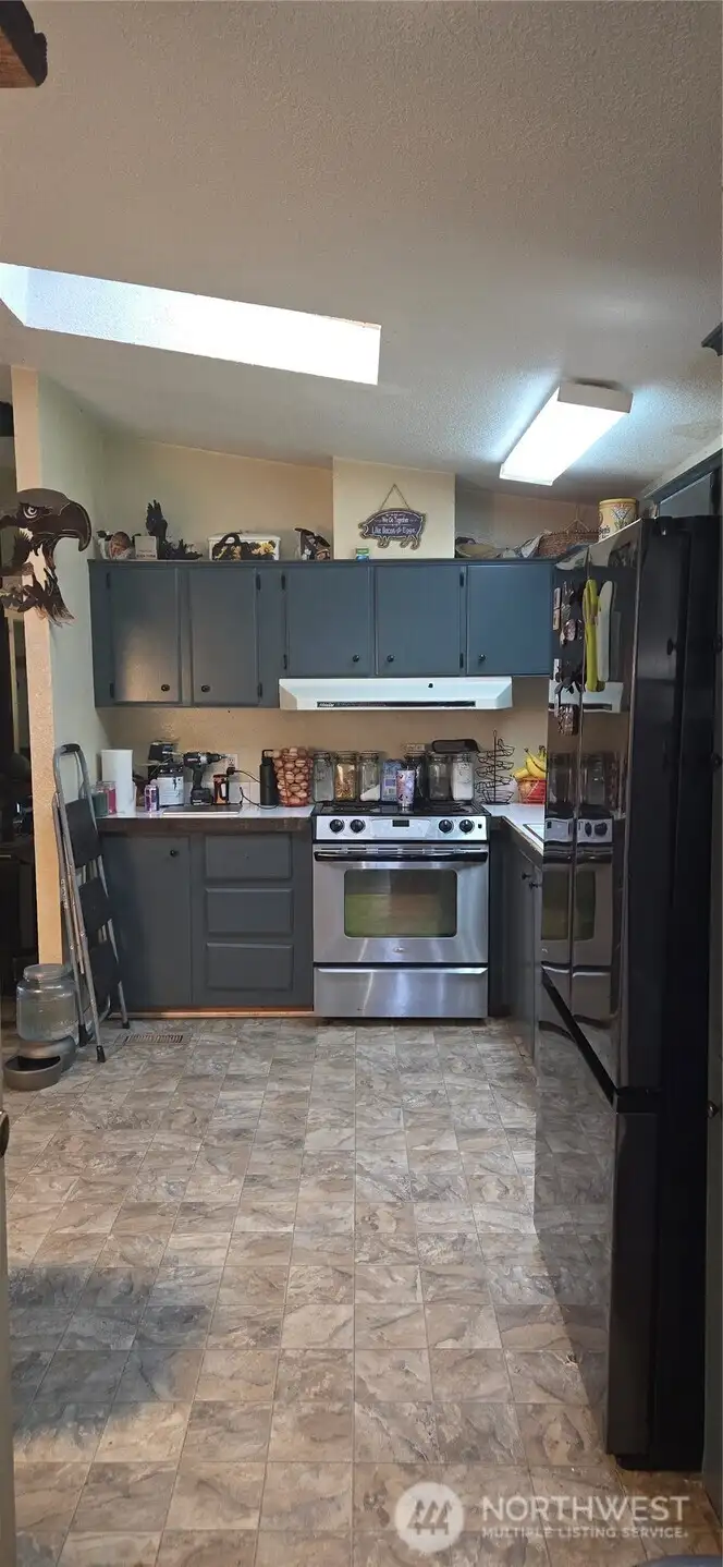 Kitchen with freshly painted cabinets & stainless appliances
