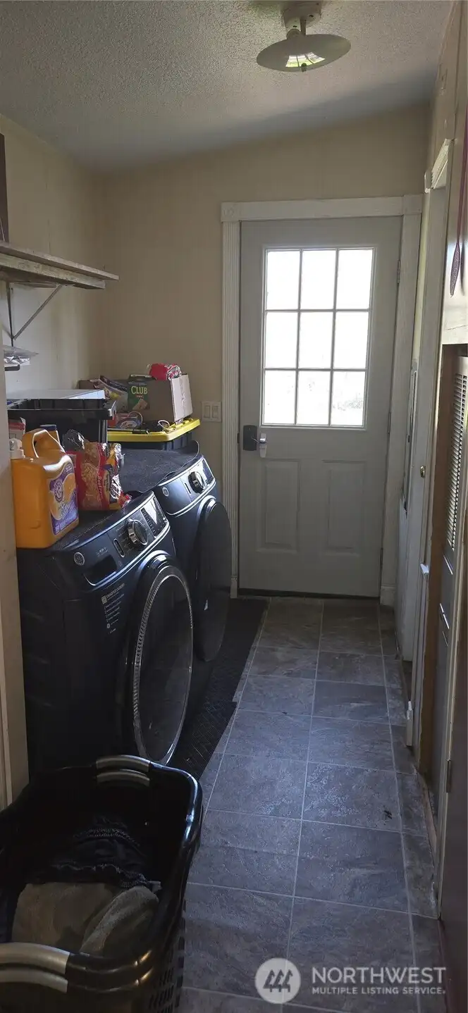 Side entrance into laundry room. Also has door into primary bathroom.