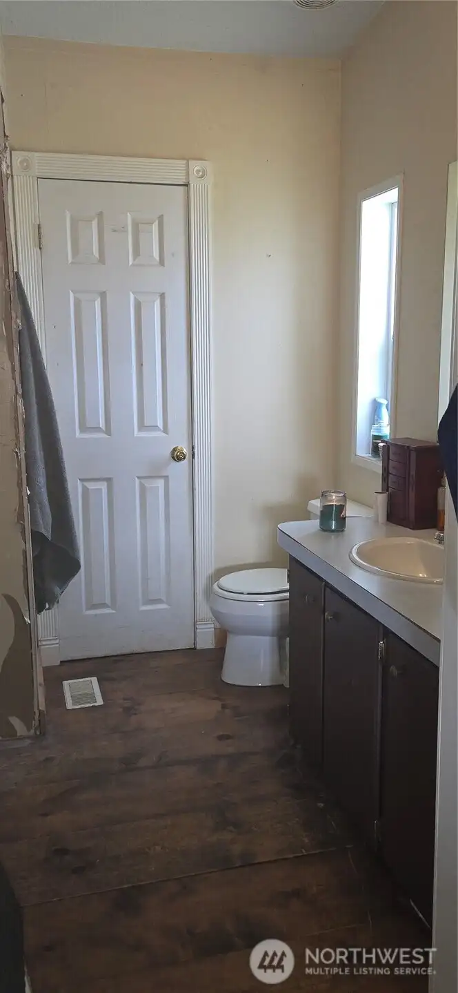 Primary bathroom with separate door into laundry room.