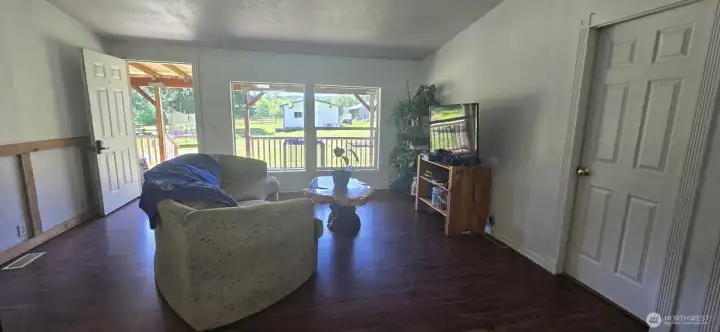 Living Room looking out the windows to covered front deck