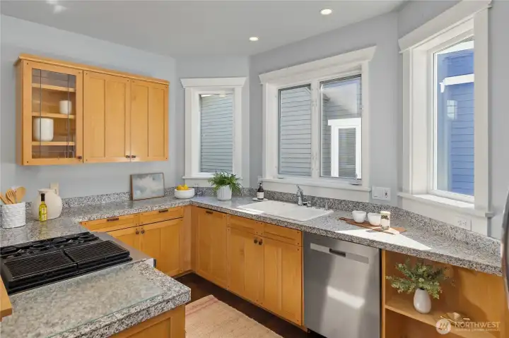 The well designed kitchen features maple cabinets ,granite, a propane cook top, stainless appliances and generous cabinets for storage.