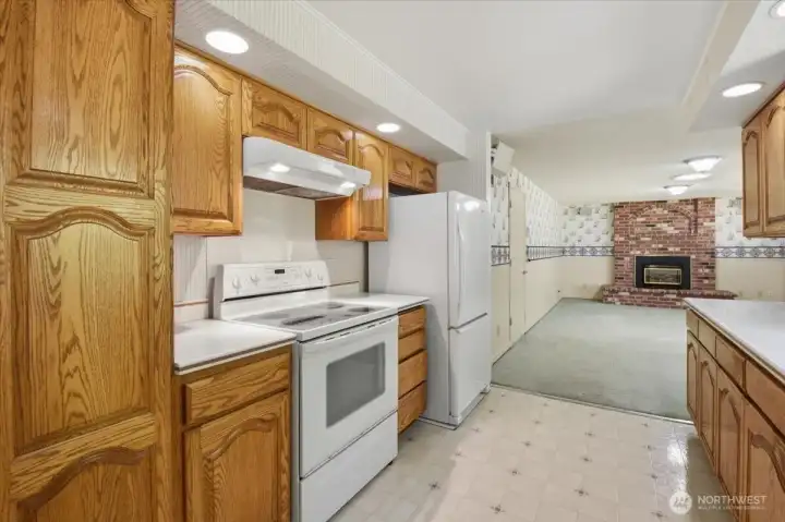 Galley Kitchen with nice amount of storage looking towards the family room.