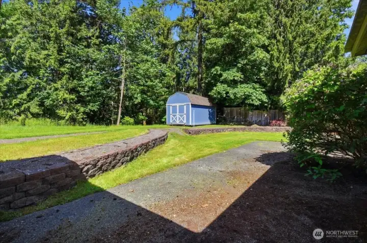 Patio with a terraced flowerbed just waiting to be planted.
