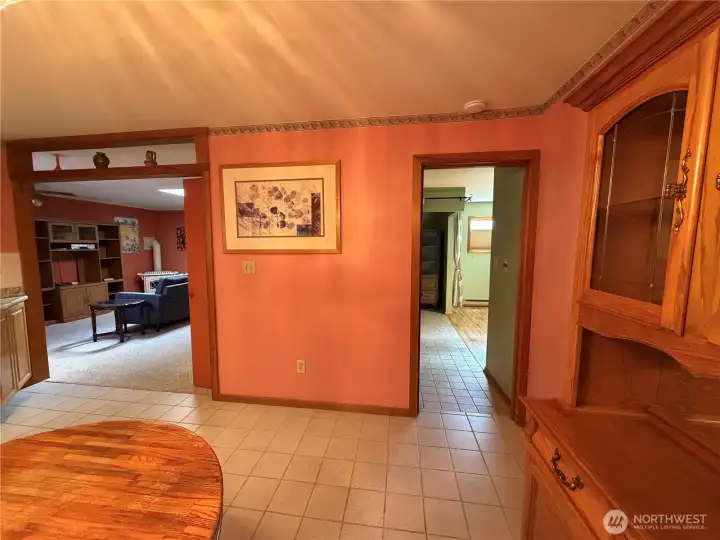 From the dining room & kitchen with the family room at left, handicapped bedroom to the right. From the dining room & kitchen with the family room at left, handicapped bedroom to the right.