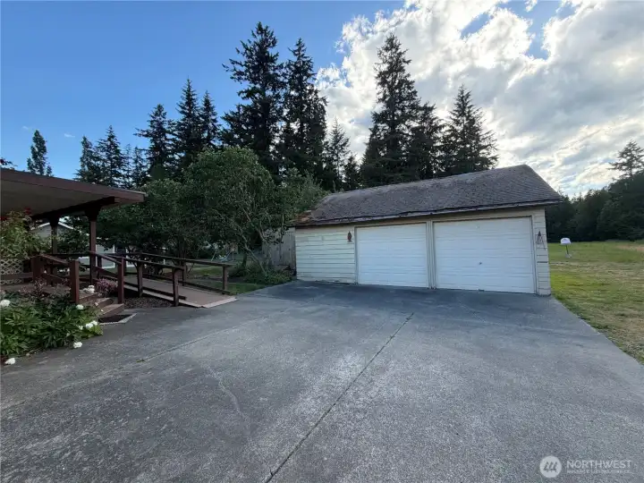 2 car garage with shop space. Level concrete pad for easy mobility from home to garage. 2 car garage with shop space. Level concrete pad for easy mobility from home to garage.