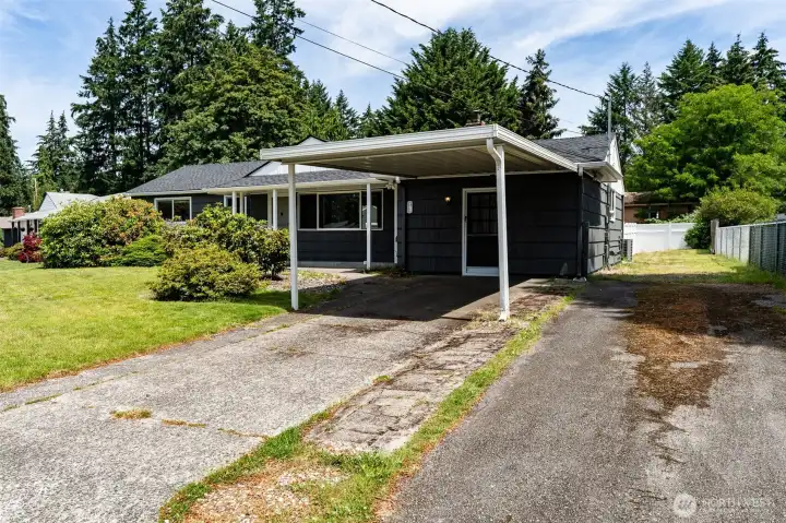 Front view of home, this adorable rambler has a carport, main driveway AND secondary driveway enabling so much parking for you, your guests, boat, RV...